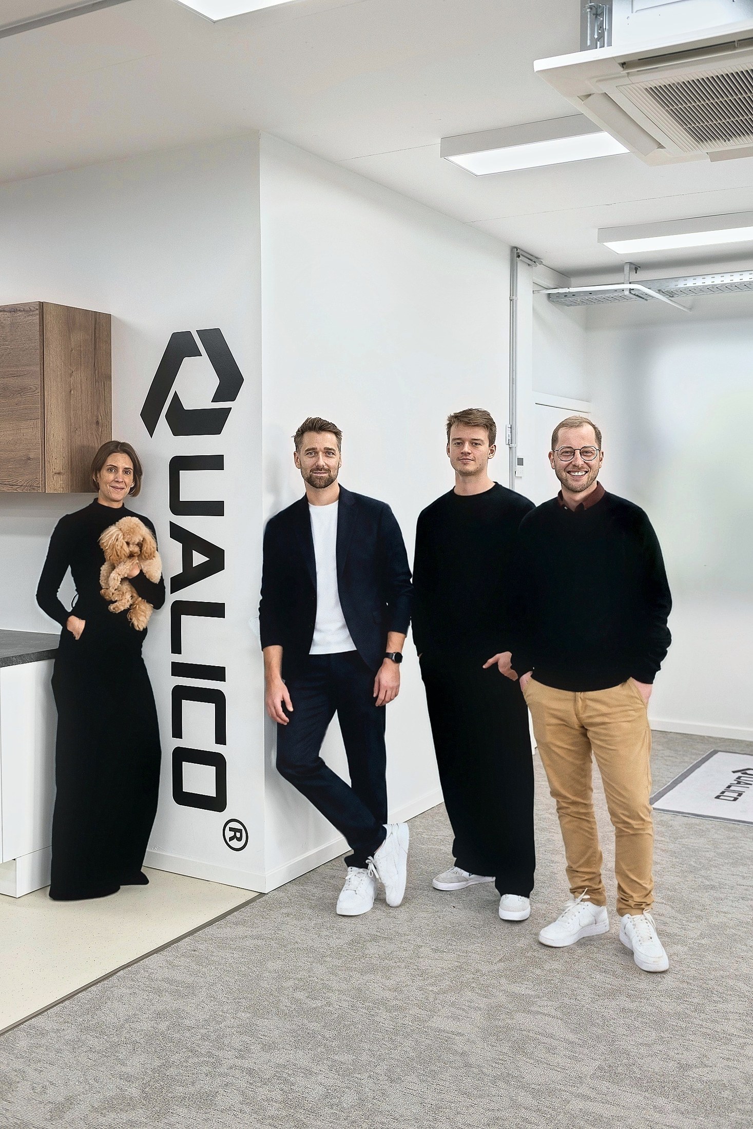The Qualico team by the studio logo wall