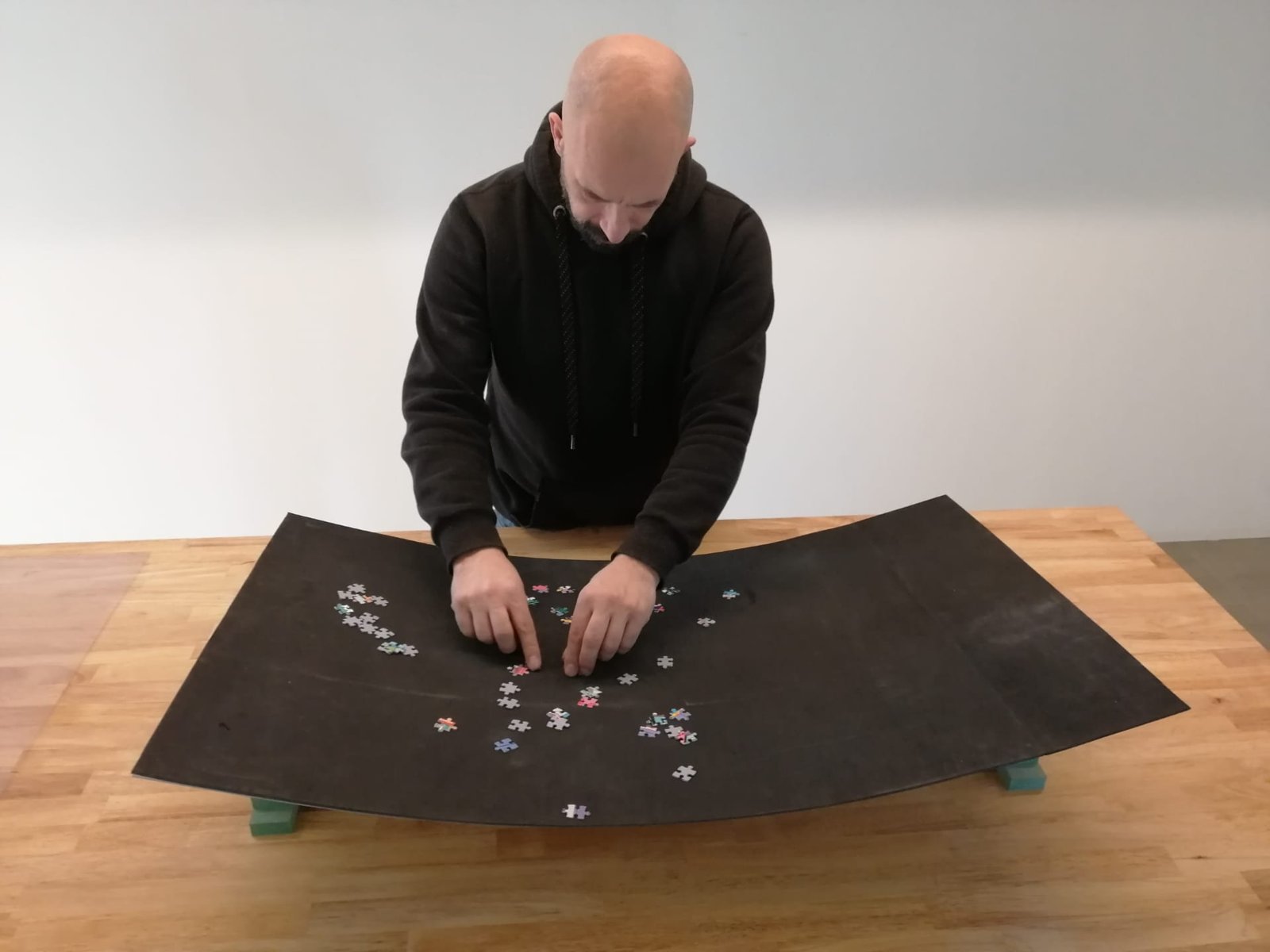 Puzzle pieces sorted on the mat at a work table