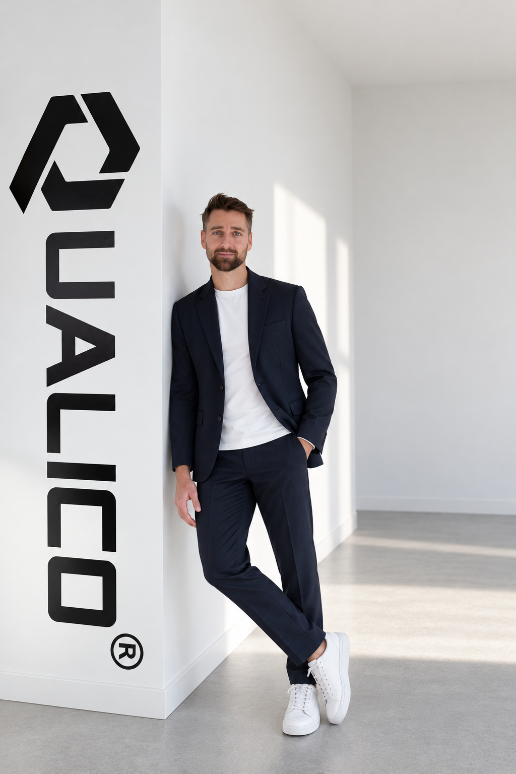 Tim Huybrechts, founder of Qualico, at the studio logo wall