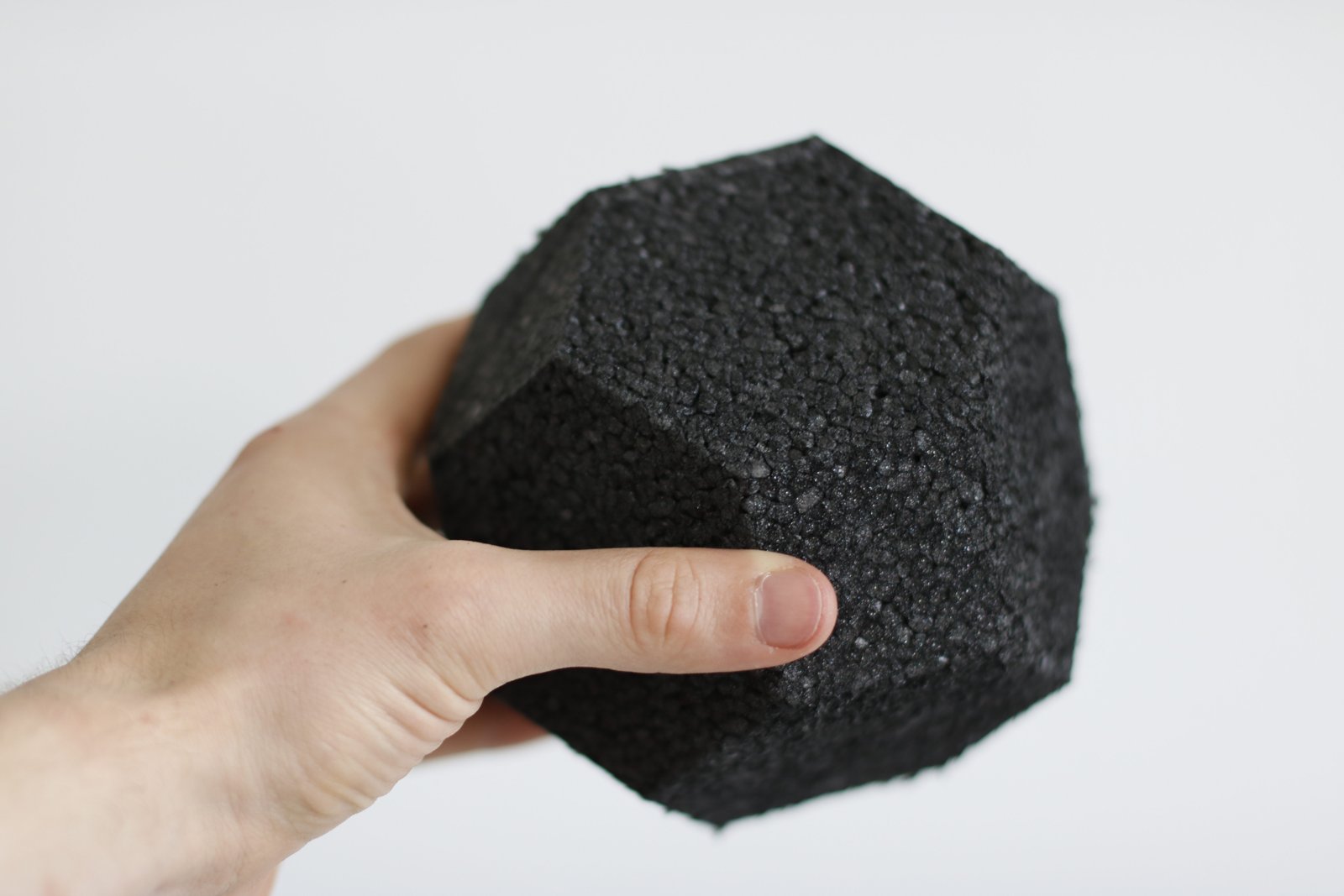 Hand holding a machined EPP building block
