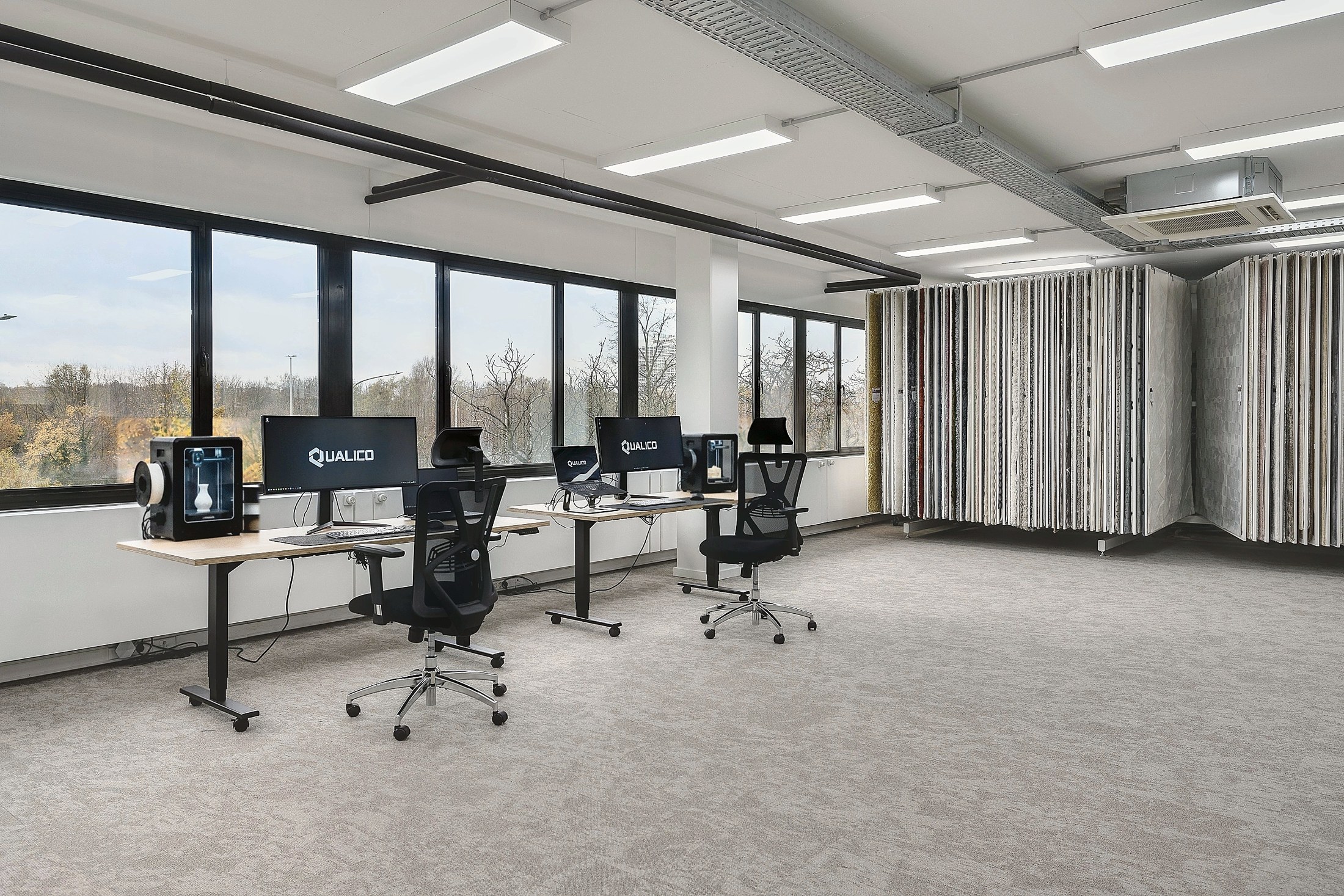 Workstations beside the Qualico studio windows