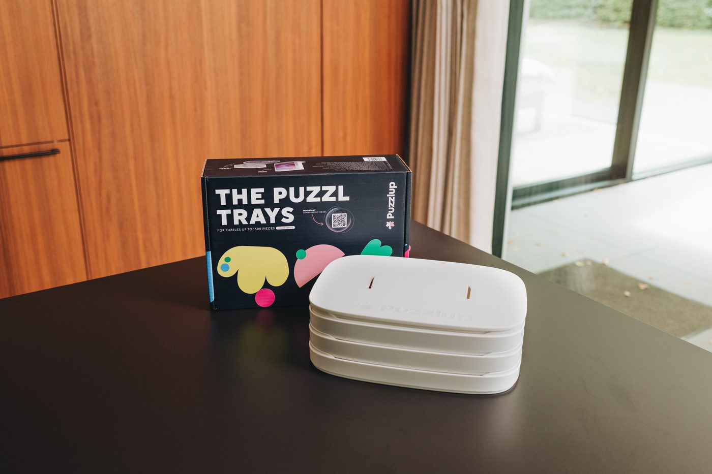 White Puzzlup sorting trays next to the box