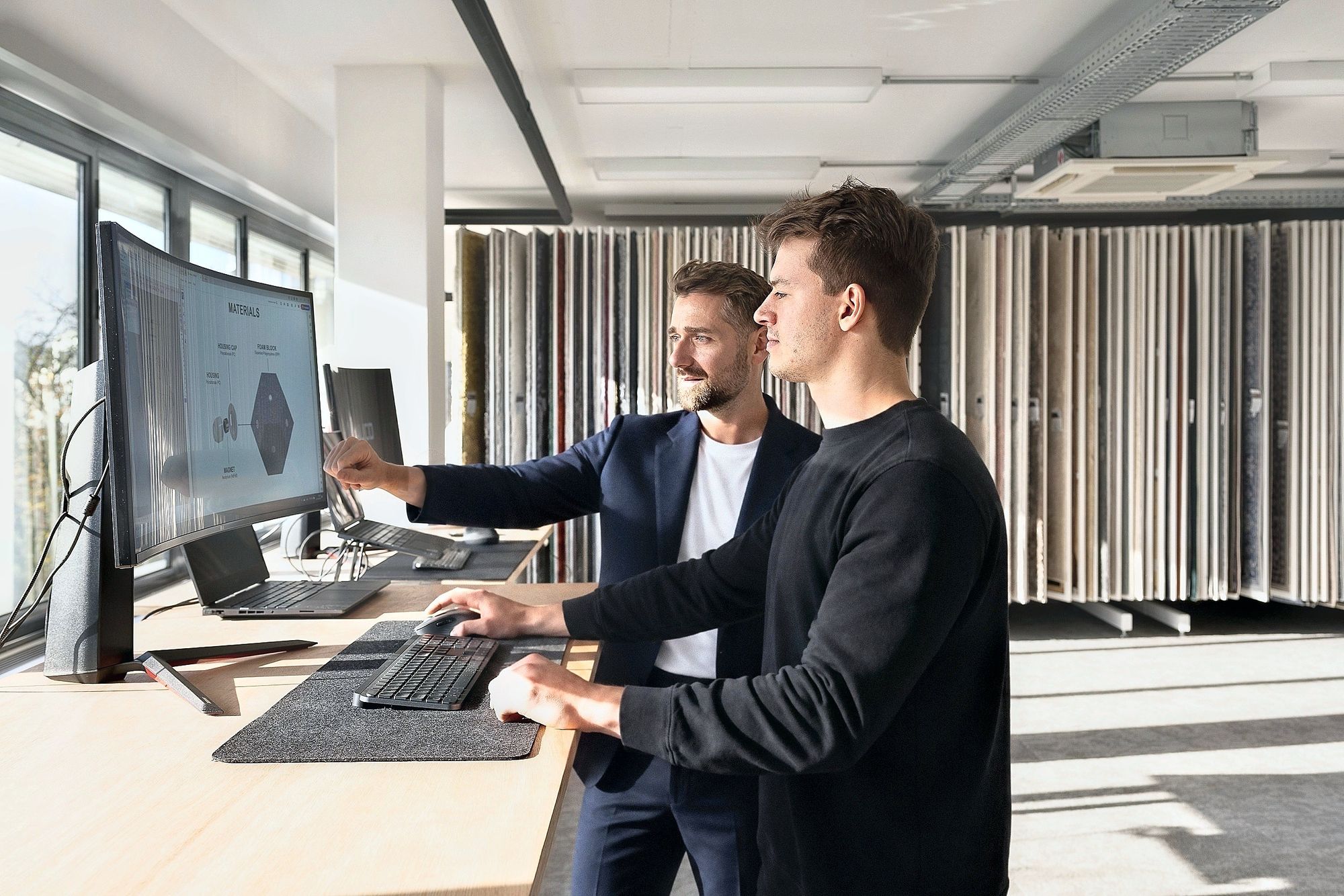Tim Huybrechts reviewing materials with a colleague
