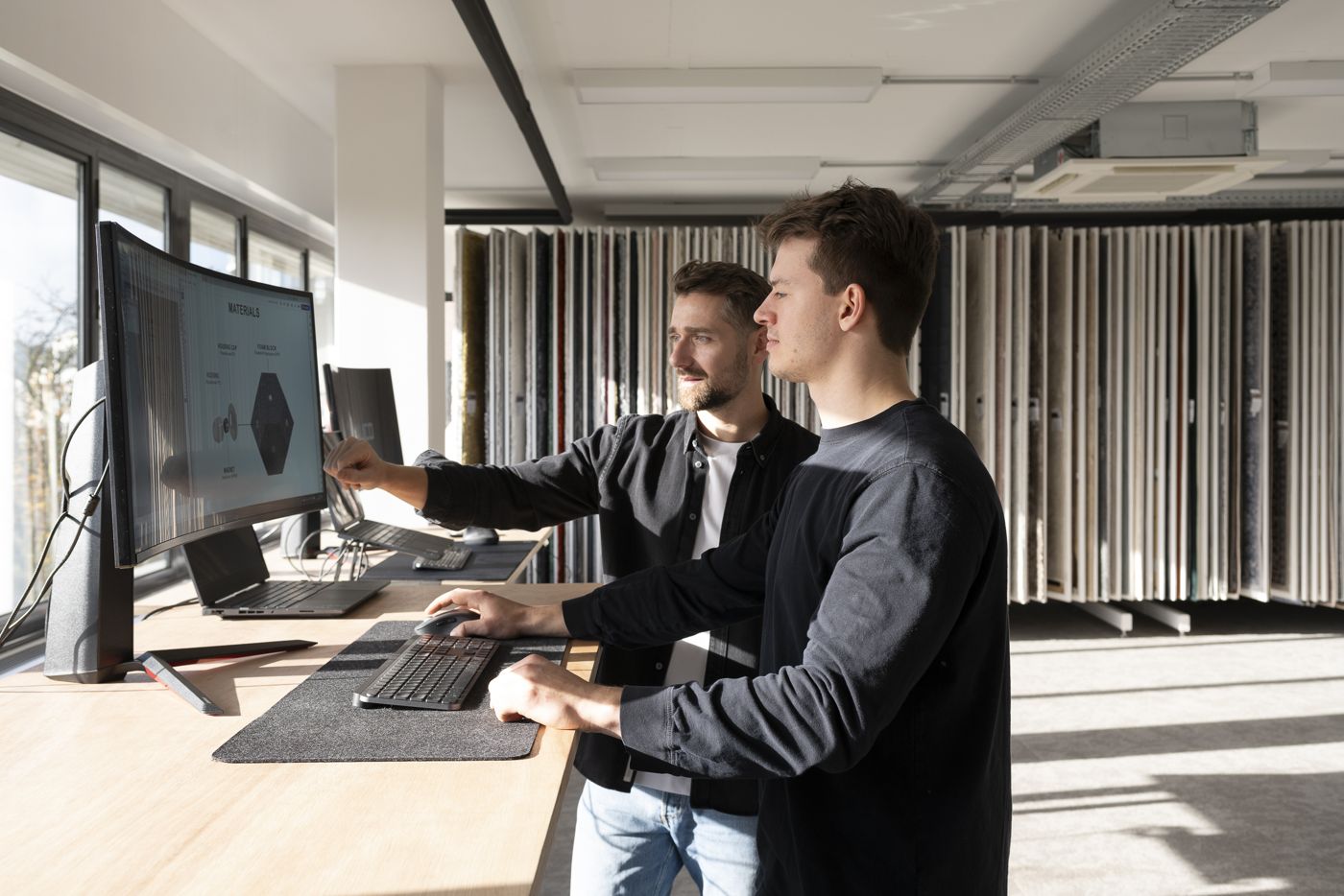 Two designers discussing a 3D model
