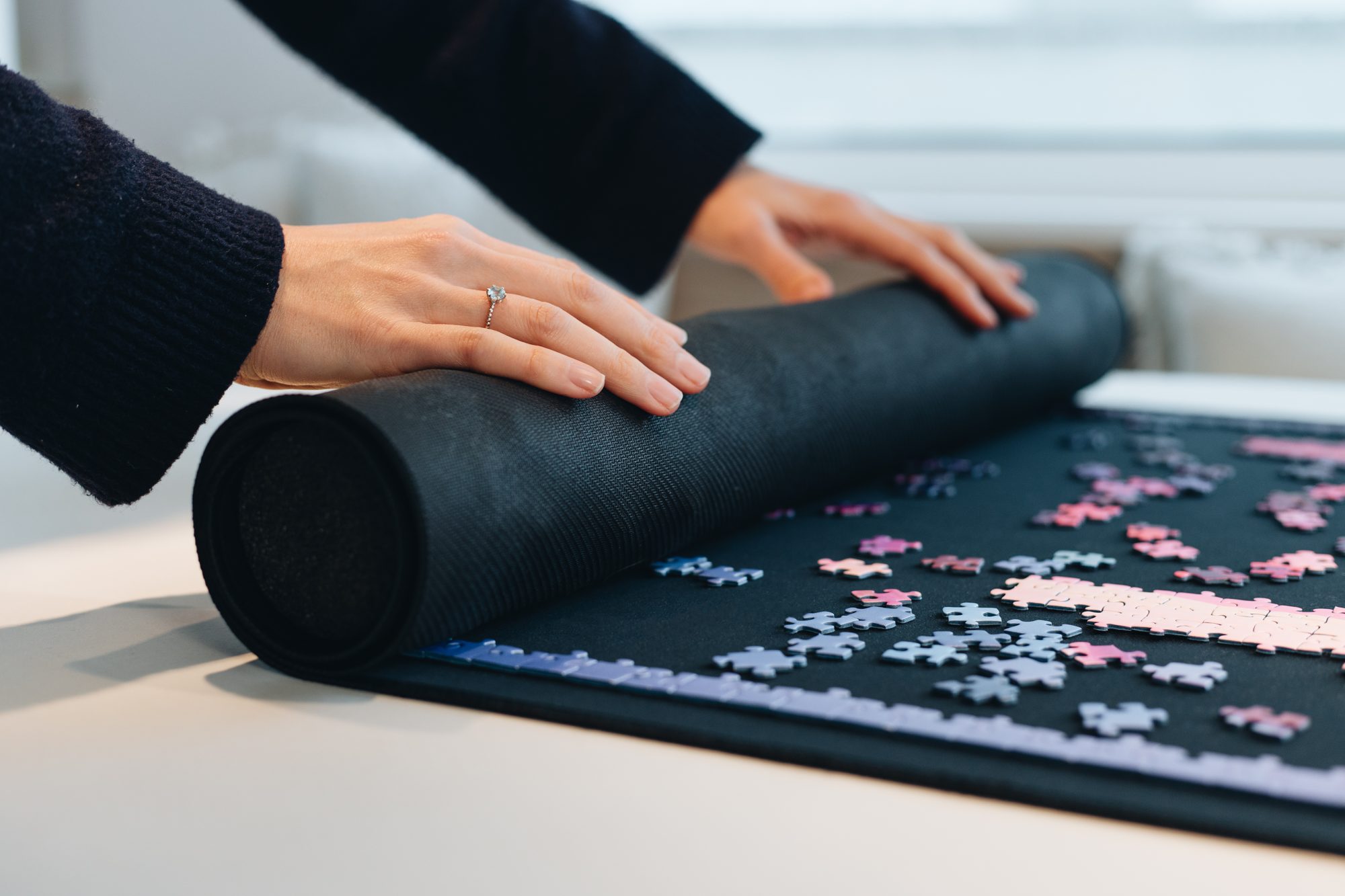 Rolling up a puzzle in progress on a Puzzlup mat